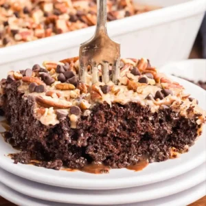German Chocolate Poke Cake 1 Poking holes in German Chocolate Poke Cake